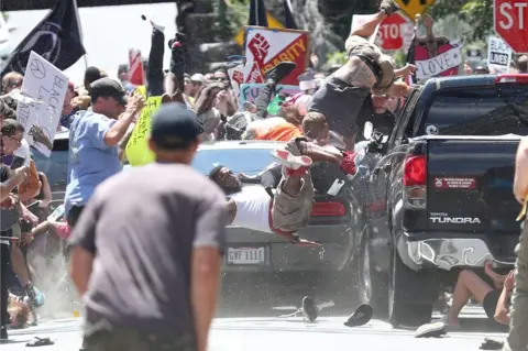 Ryan Kelly/Daily Progress Ryan Kelly took 80 pictures as the car sped past, on his last day as a photographer. He won the Pulitzer Prize for this frame