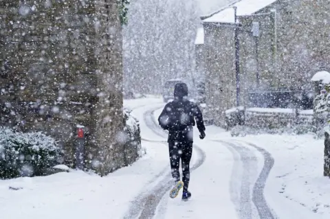 Danny Lawson/PA Media A man runs through the snow in Gunnerside, North Yorkshire. Picture date: Sunday November 28, 2021. PA Photo. Winter woollies will be needed amid freezing conditions in the aftermath of Storm Arwen which wreaked havoc across much of the UK. Temperatures were expected to struggle to get above freezing in some parts, with minus 1C (33.8F) forecast in some areas