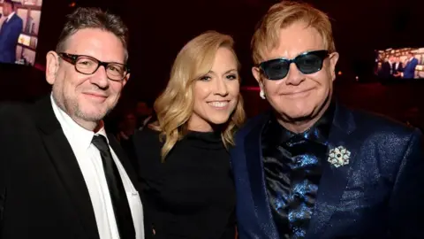 Getty Images Sir Lucian Grainge (left) with Sheryl Crow and Elton John