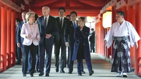 Getty Images G7 leaders walk with a priest at a shrine in Hiroshima, Japan. Photo: 19 May 2023