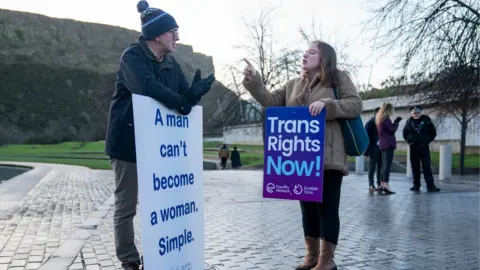 PA Media A member of the Scottish Family Party (left) and a supporter of the Gender Recognition Reform Bill outside the Scottish Parliament