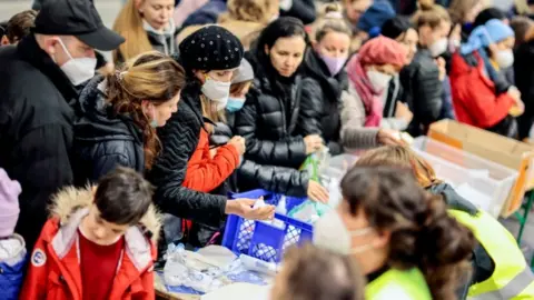 Reuters Refugees receiving aid in Berlin, Germany
