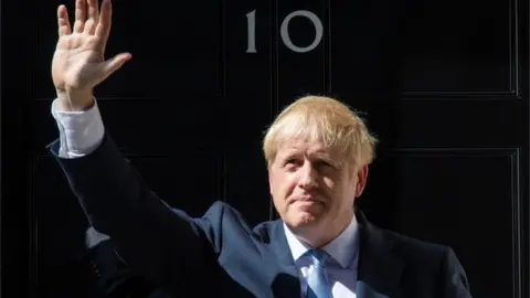 PA Media File photo dated 24/07/19 of new Prime Minister Boris Johnson waving outside 10 Downing Street,