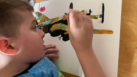 Sara Berry Jack Berry painting an aeroplane