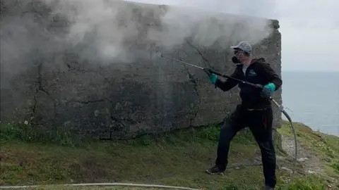 Andrew Carr Grafitti cleaning at Rame Head Chapel