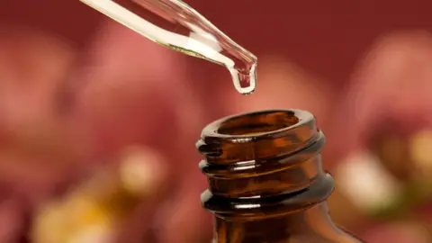Getty Images Essential oil dripping in bottle