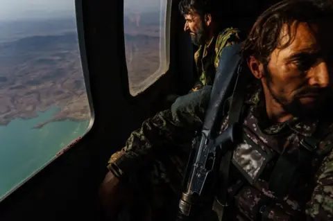 Getty Images Wounded Afghan soldiers aboard a helicopter north of Kandahar, Afghanistan, 6 May