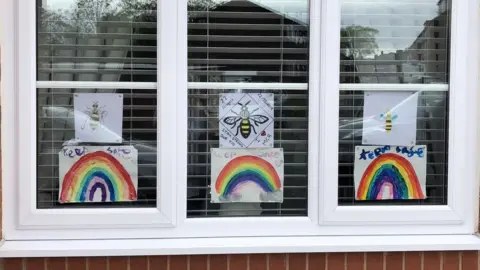 Sharon Armstrong Bees and rainbow pictures in window
