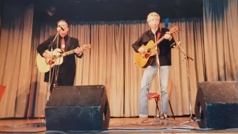 Elvis Costello performing alongside Nick Lowe (r) at the 1988 Shetland Folk Festival