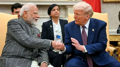 AFP via Getty Images US President Donald Trump (right) wearing a blazer and a tie, shakes hands with Indian Prime Minister Narendra Modi (left) in the Oval Office of the White House on 13 February 2025