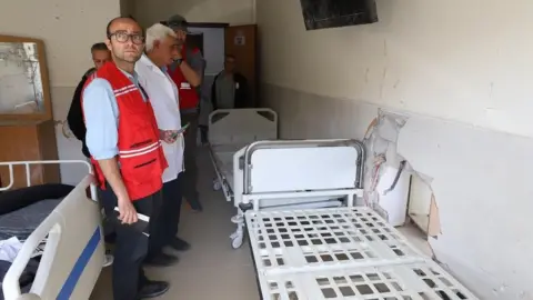 PALESTINE RED CRESCENT SOCIETY File photo showing delegates from the International Committee of the Red Cross (ICRC) visiting al-Amal hospital in Khan Younis, southern Gaza, on 21 March 2024