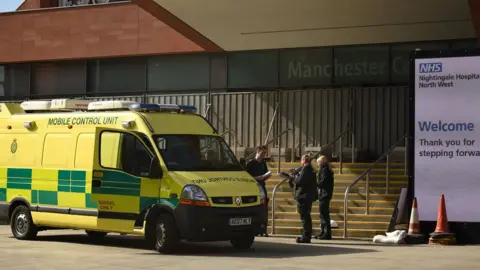Getty Images North West Ambulance Service staff work outside the "Nightingale Hospital North West", the converted Manchester Central Convention Complex, in Manchester, north-west England on April 13, 2020,