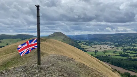 The union jack flag at half mast atop the Lawley, near Church Stretton