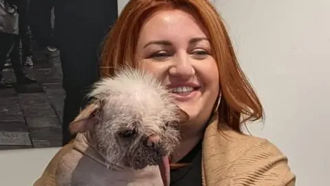 BBC Holly Middleton holding her dog, Peggy