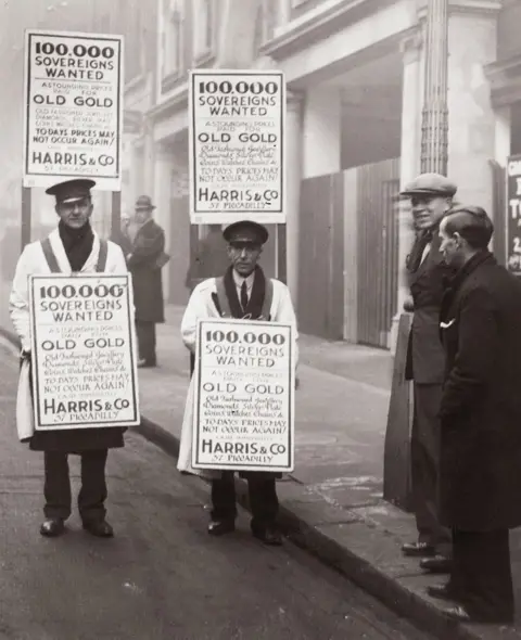 Getty Images Due to the high exchange price the gold rush in London is continuing. Sandwich men in the streets of London. Photography, 1932