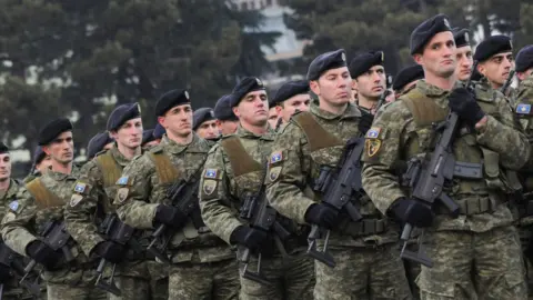 Reuters Members of Kosovo's security forces parade a day before parliament's vote on whether to form a national army, in Pristina, Kosovo, December 13, 2018