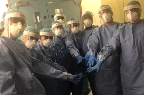 Juanita Nittla Nurses in protective equipment before the start of the shift