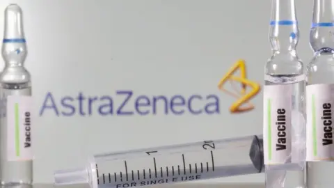 Reuters A test tube labelled "vaccine" in front of an AstraZeneca logo. File photo