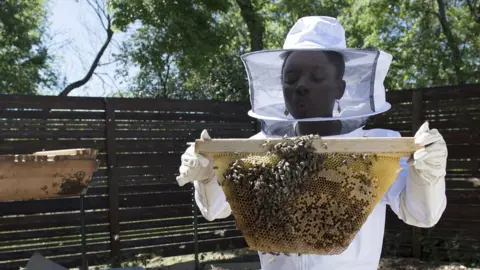 Me & The Bees Mikaila Ulmer with some bees