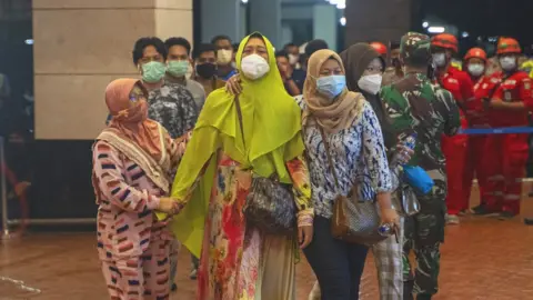 Getty Images Relatives of people on Sriwijaya Air flight SJ 182 arrive at the crisis centre in Soekarno Hatta Airport, on 9 January 2021 in Jakarta, Indonesia