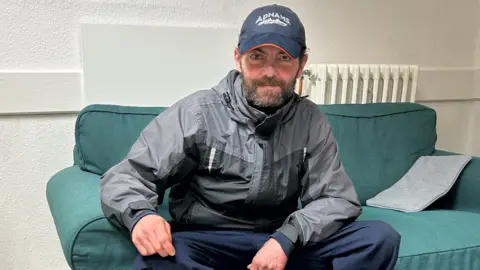 King's Arms Project Ovidiu doing a puzzle at a Bedford night shelter