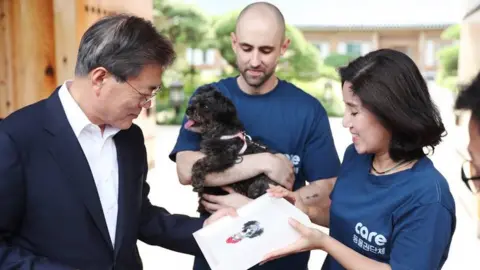 Cheong Wa Dae handout President Moon of South Korea receives his new dog Tory at the CARE animal sanctuary