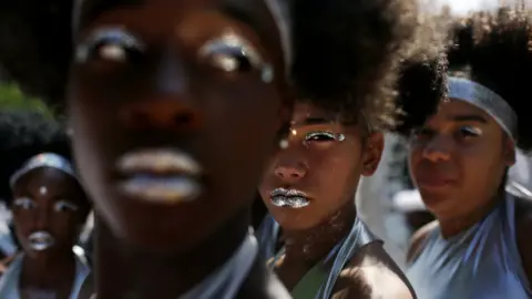 The Visions In Motion dance group prepares to march down Eastern Parkway for the West Indian American Day Parade in celebration of the Caribbean Carnival in the Brooklyn borough of New York City, on 4 September 2017