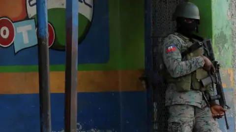 Reuters A Haitian soldier keeps watch near the Toussaint Louverture International Airport following a gunfight with armed gangs on the surroundings of the airport, as the government declared state of emergency amid violence, in Port-au-Prince, Haiti, March 4, 2024.