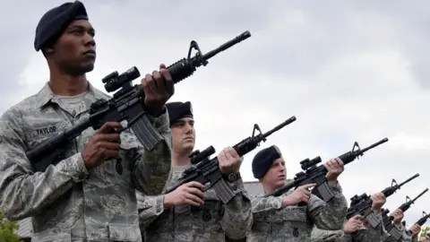 US DoD US service personnel carrying assault rifles