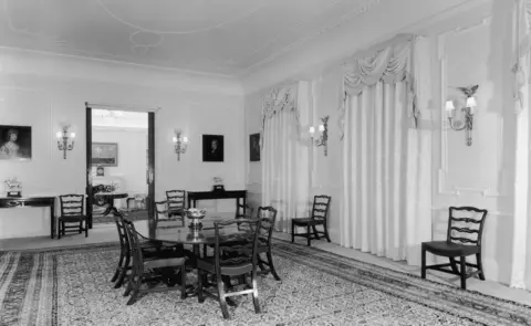 Getty Images The dining room of Clarence House in London, 1949. The house was built in 1825-27 by John Nash for the Duke of Clarence, later King William IV. The dining table and chairs are mahogany and the curtains are white figured damask