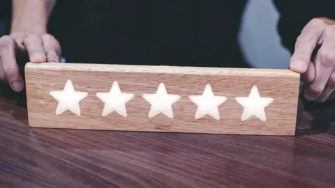 Getty Images Five stars on a wooden board