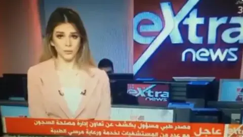 Extra News Screen grab of female news presenter announcing Mohammed Morsi's death