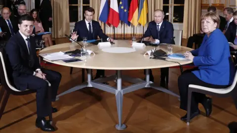 EPA (L-R) Ukrainian President Volodymyr Zelensky, French President Emmanuel Macron, Russian President Vladimir Putin and German Chancellor Angela Merkel, during a summit on Ukraine at the Élysée Palace in Paris, France, 9 December 2019