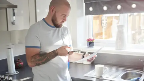 Getty Images Man looking a bill