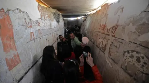 AFP Egyptians look at well-preserved and rare wall paintings inside the tomb of an Old Kingdom priestess in Saqqara, on the Giza plateau on the southern outskirts of Cairo, that was unveiled on 3 February 2018,