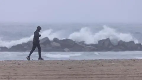 Reuters man jogging on beach