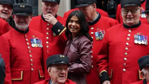 PA Media Akshata Murty, wife of Prime Minister Rishi Sunak, poses with a group of Chelsea Pensioners in Downing Street, London, where she hosted a reception ahead of Armistice Day