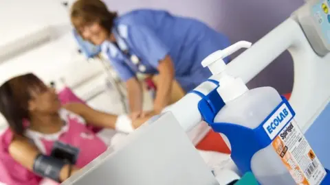 Science Photo Library Hospital bed - with hand-washing gel