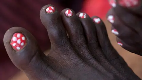 AFP Women with bright nails