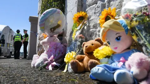 Getty Images Soft toys, flowers and dolls have been left for the schoolgirl