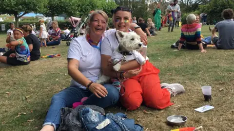 Hayley Rowe holding a dog at Pride