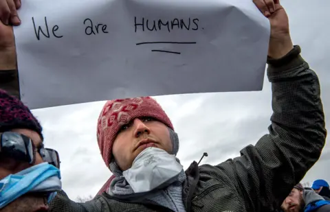 Getty Images Iranian protester at Calais migrant camp (March 2016)