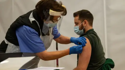 Getty Images Vaccination in Cwmbran in December of a health worker