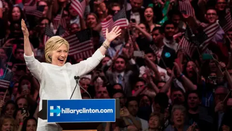 Getty Images Hillary with her arms up high during a rally