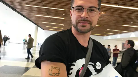 Kristoffer Hellen shows off his Bernie tattoo,