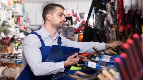 Getty Images Man working in hardware store