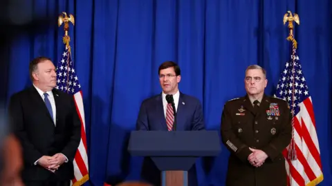 Reuters US Defence Secretary Mark Esper (centre) speaks about the US air strikes on an Iran-backed Iraqi militia at a news conference in Florida (29 December 2019)