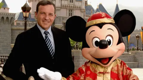 Getty Images Roger Iger and Mickey Mouse in Hong Kong Disneyland Park