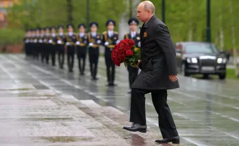 Getty Images Russia's President Vladimir Putin lays flowers at the Tomb of the Unknown Soldier