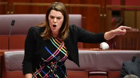 EPA Sarah Hanson-Young speaks in the Senate, with her finger pointing sharply across the chamber